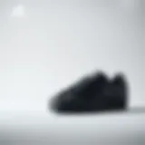 Stylish black Adidas Superstar shoes on a minimalist background