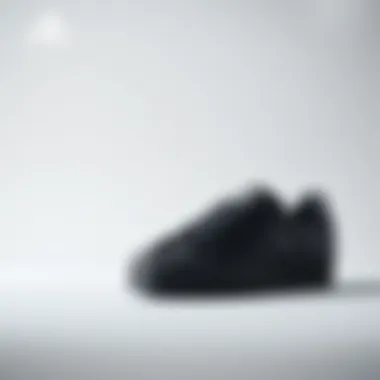 Stylish black Adidas Superstar shoes on a minimalist background