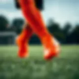 Dynamic action shot of Nike Mercurial orange soccer cleats on the field