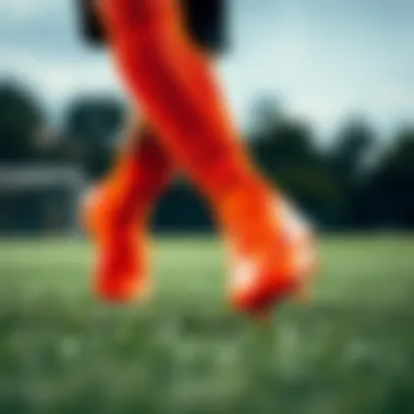 Dynamic action shot of Nike Mercurial orange soccer cleats on the field